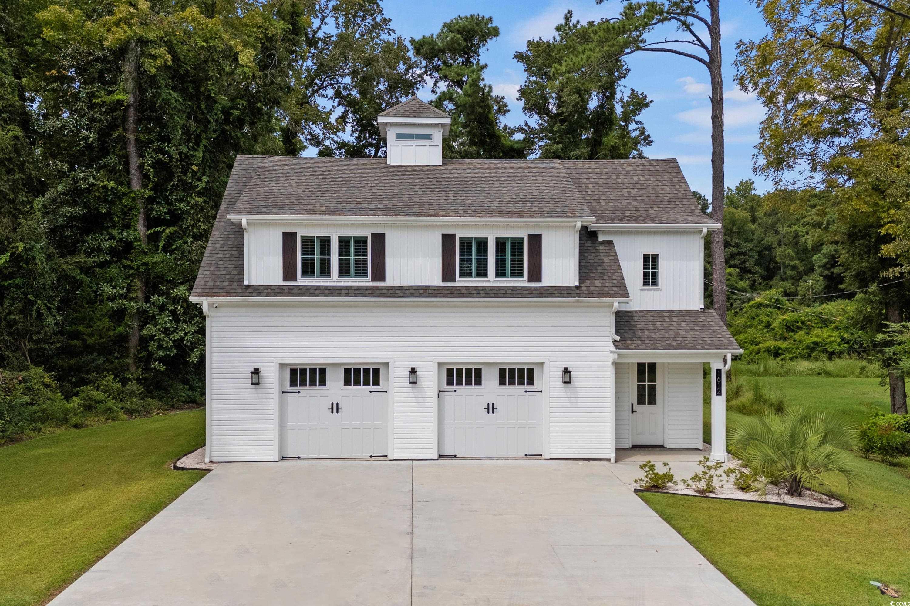 View of front of property featuring a garage and a