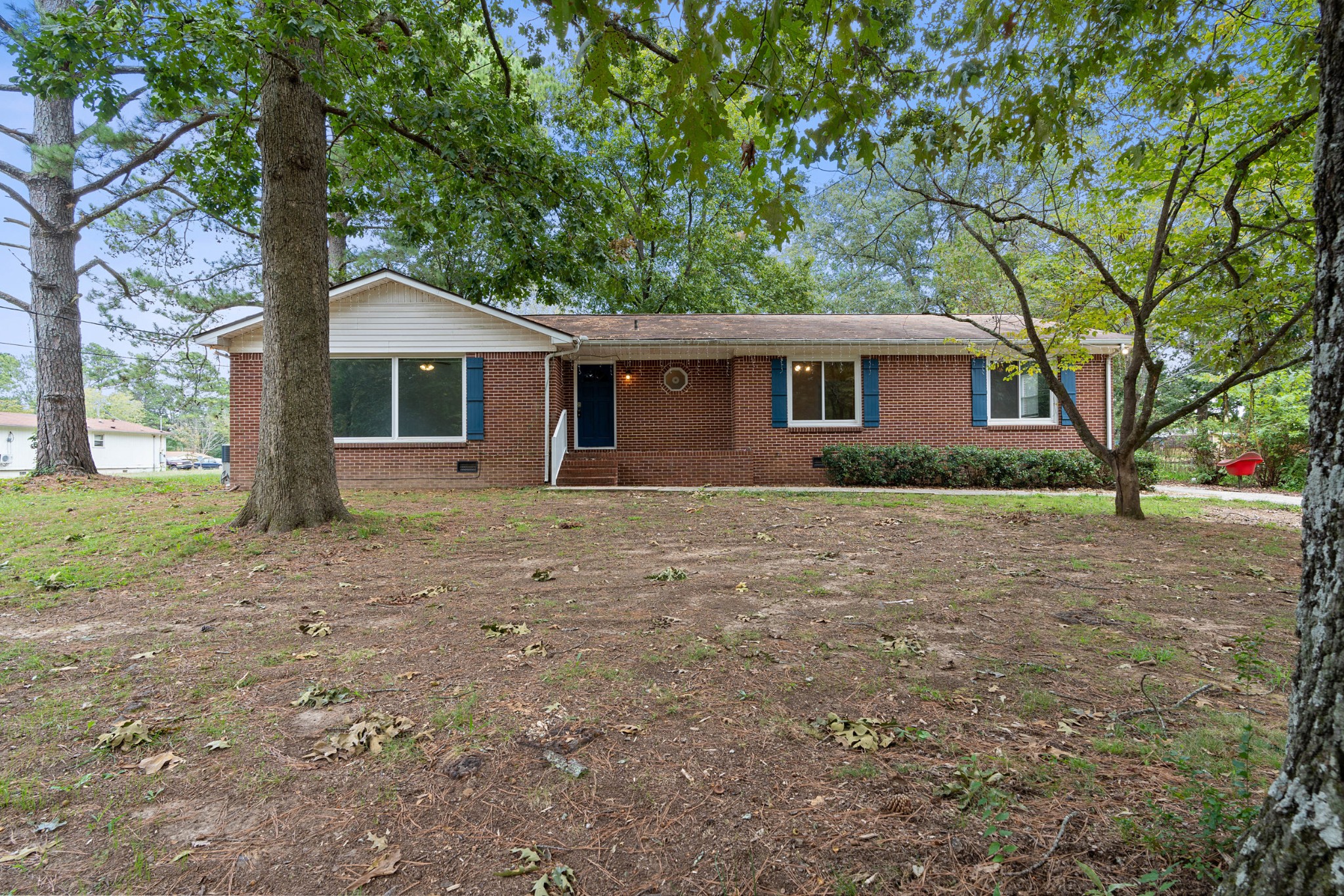 a front view of house with yard and trees