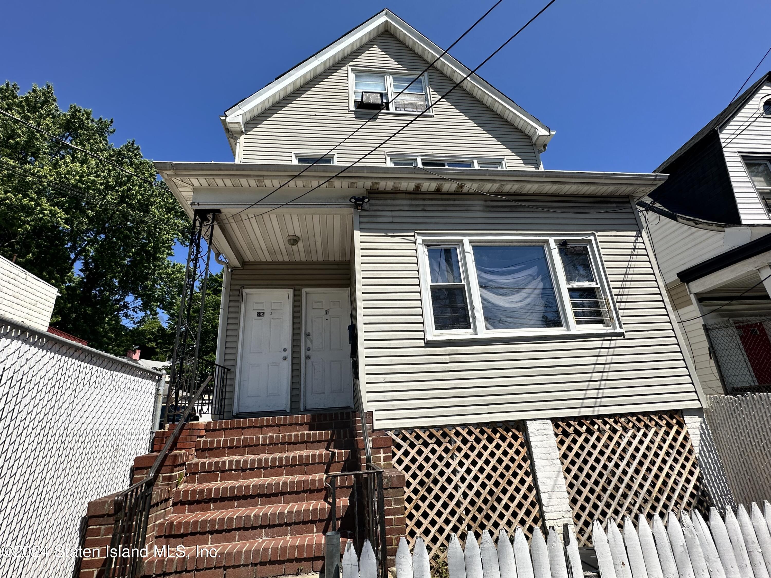 a front view of a house with a fence