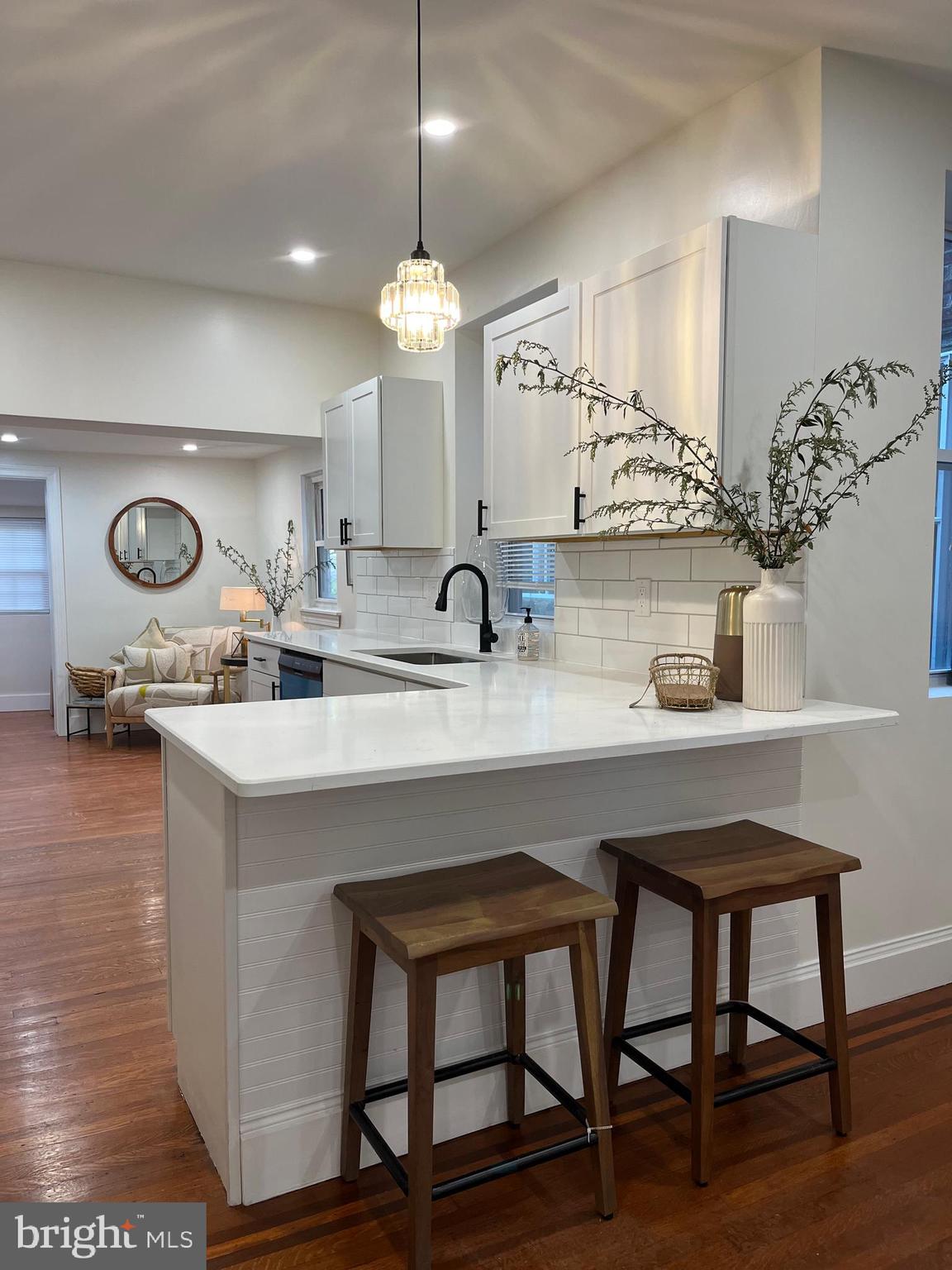 a kitchen with cabinets and chairs