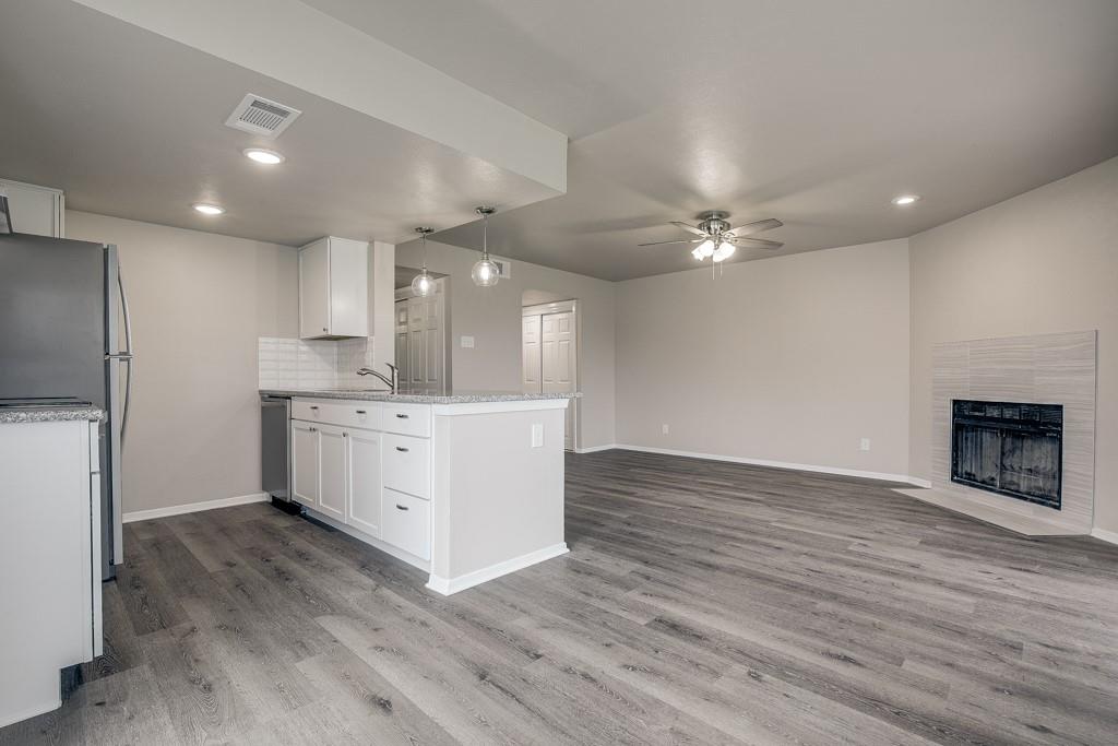 a view of kitchen with cabinets and wooden floor