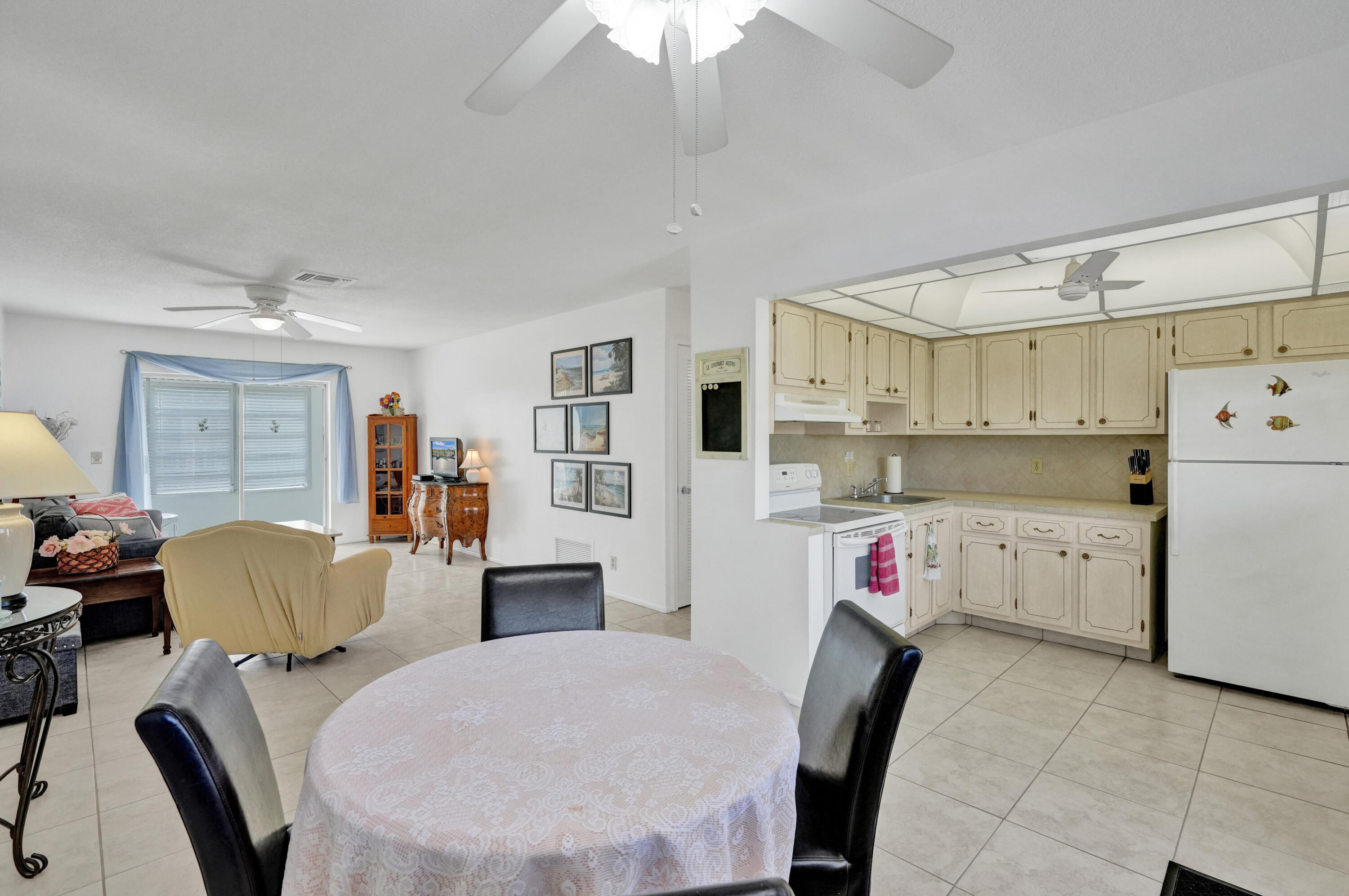 a view of kitchen with stainless steel appliances granite countertop a dining table and chairs