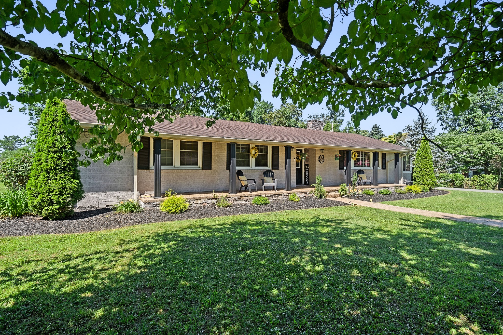 a view of a house with swimming pool and sitting area