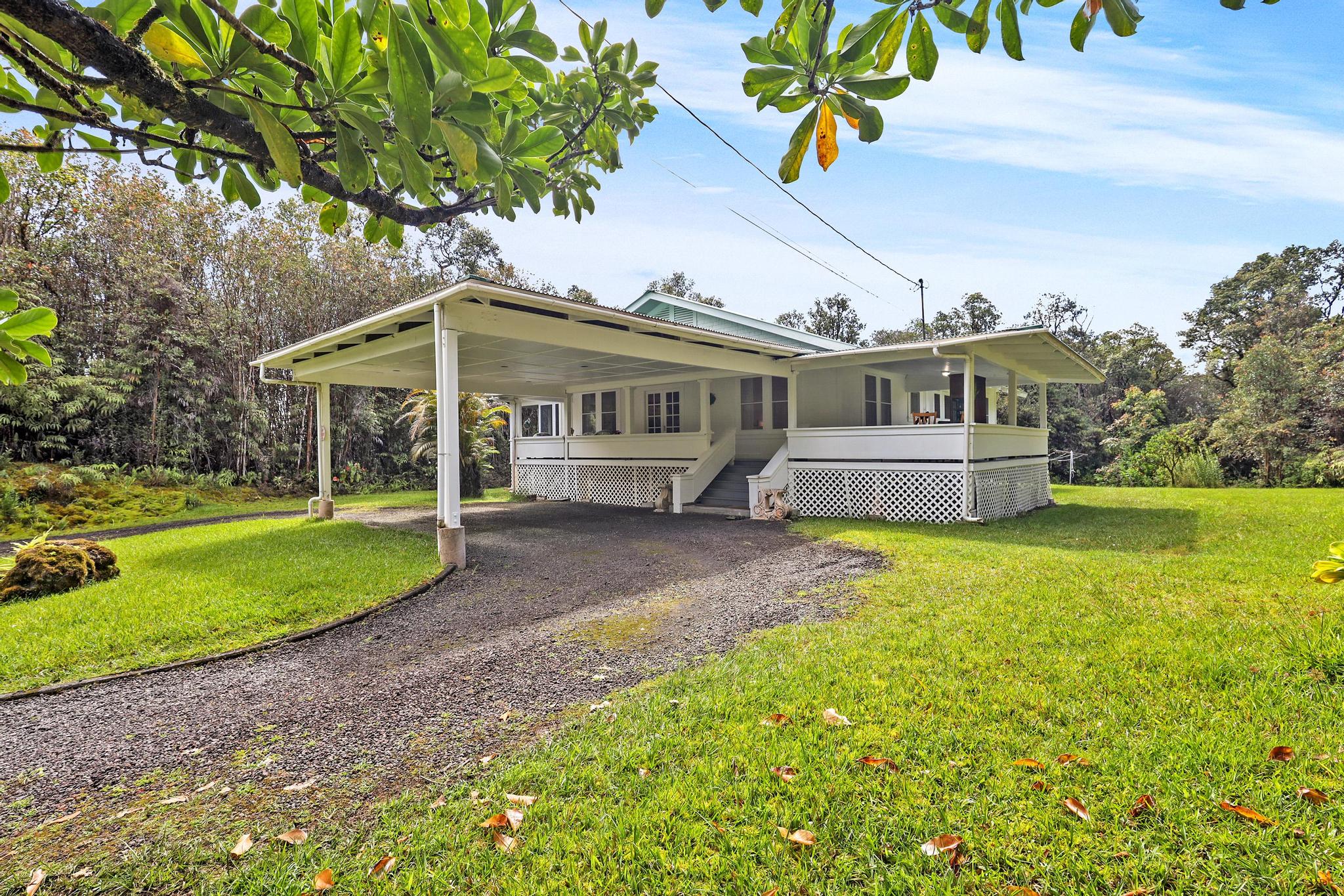 The home sits approximately half way in on the 2.5 acres with a horseshoe drive and porte-cochere