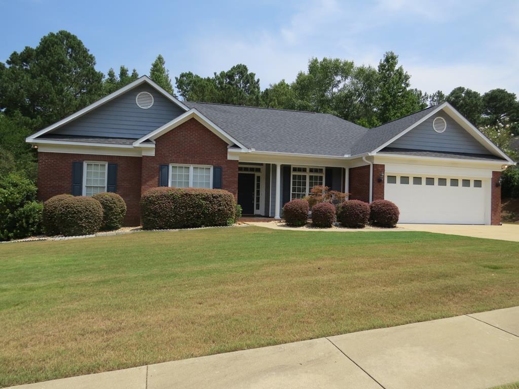 a front view of a house with a garden