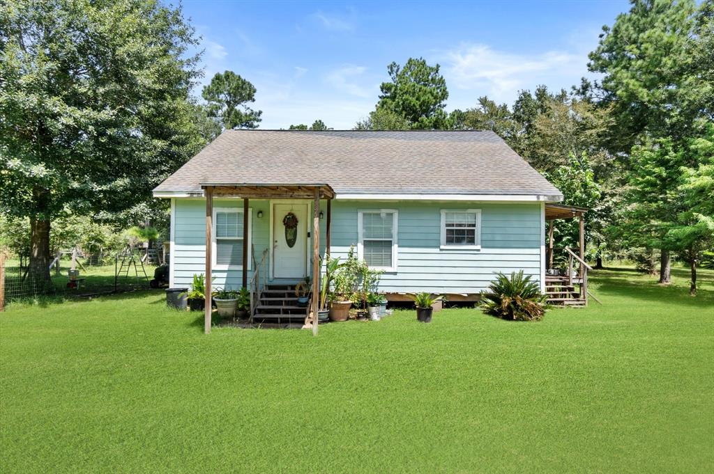 a front view of house with a garden