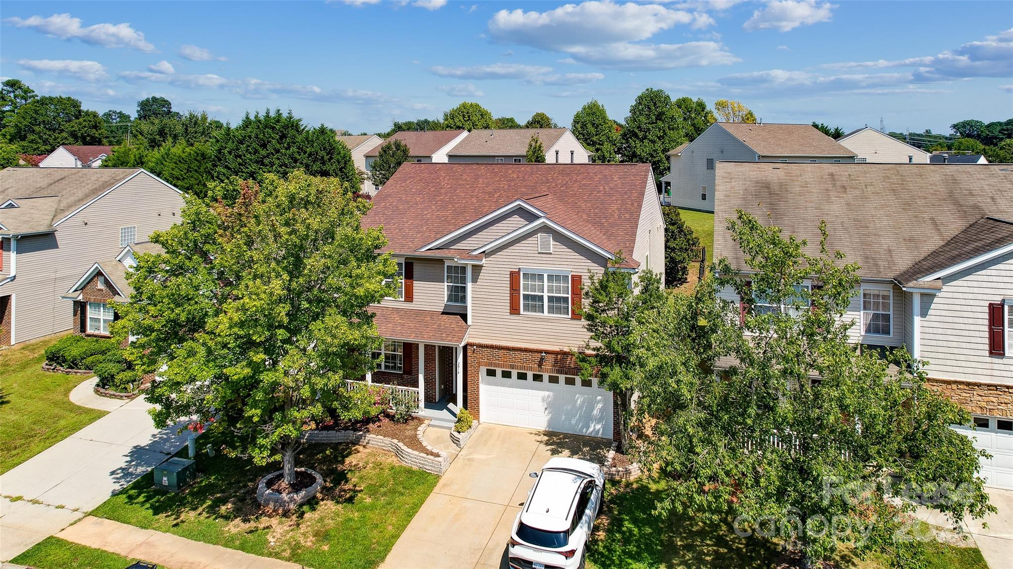 a aerial view of a house with a yard and potted plants