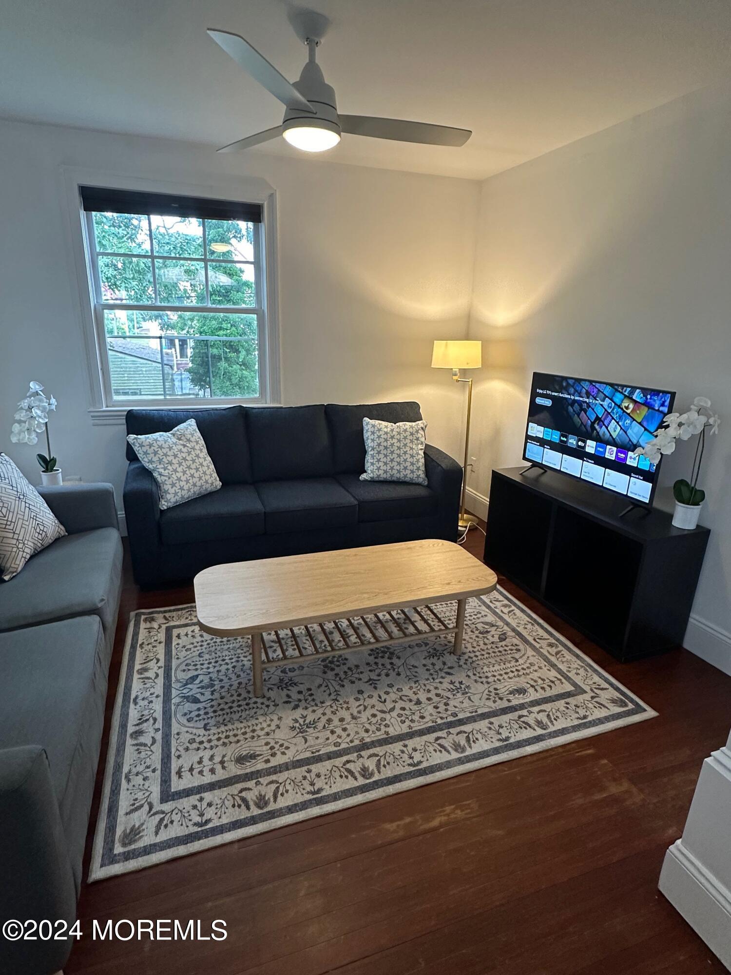 a living room with furniture and a rug