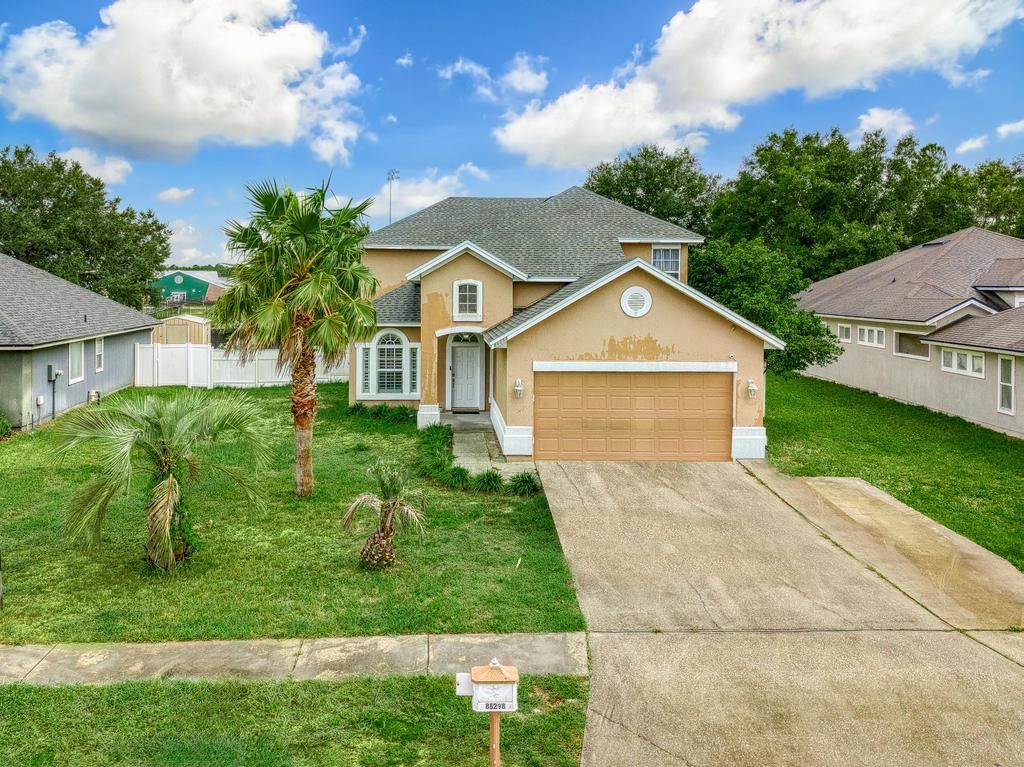 a front view of a house with a yard and garage