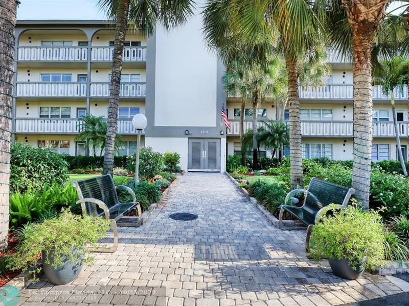 a view of a palm trees in front of a building