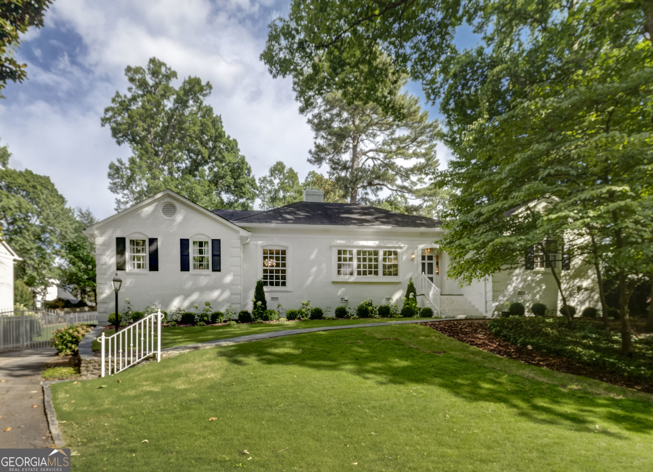 a front view of house with yard and green space