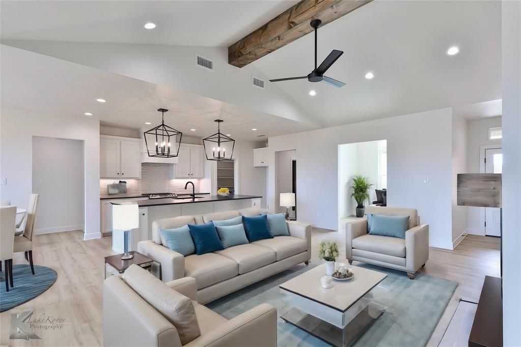 a living room with furniture kitchen view and a table