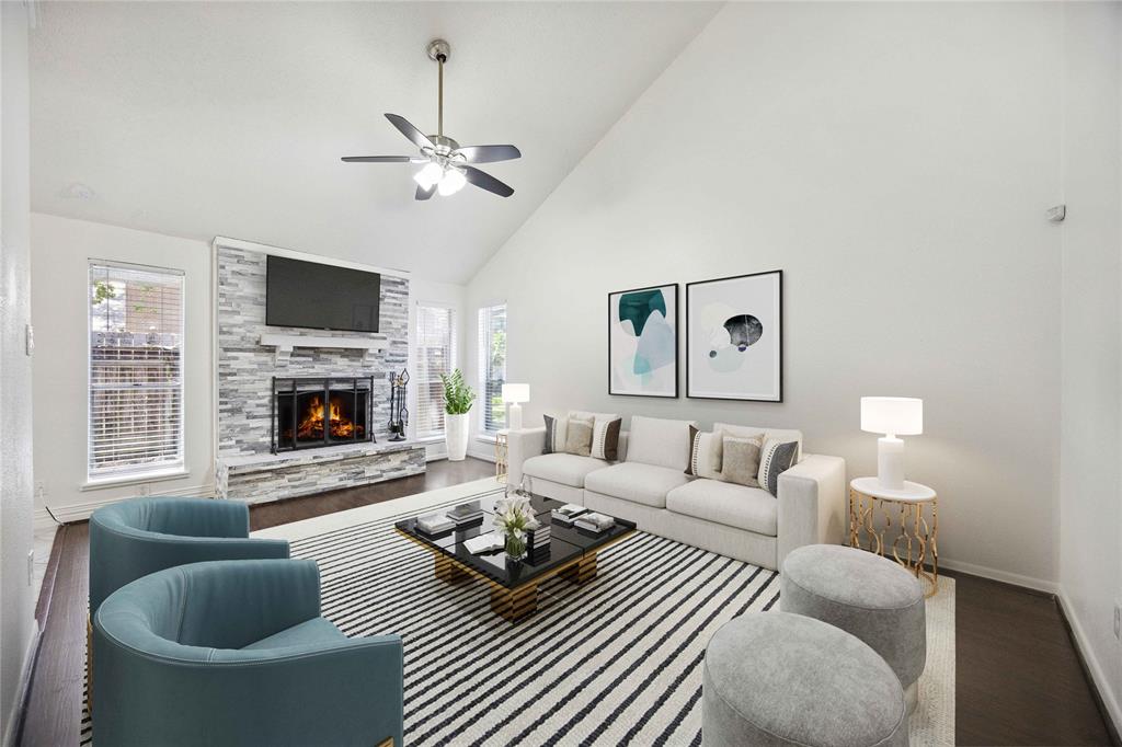 a living room with furniture a fireplace and a flat screen tv