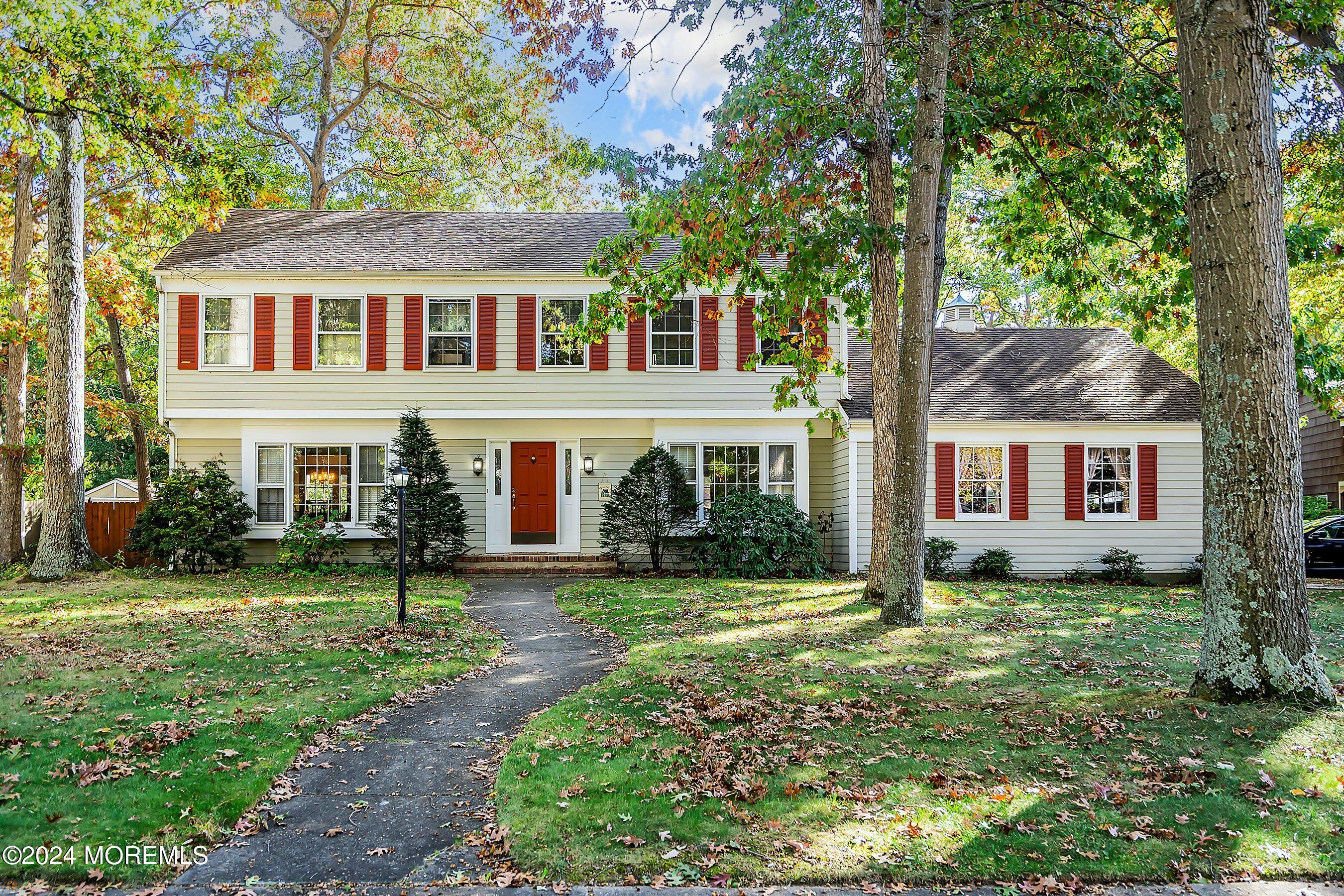 a front view of house with yard and green space