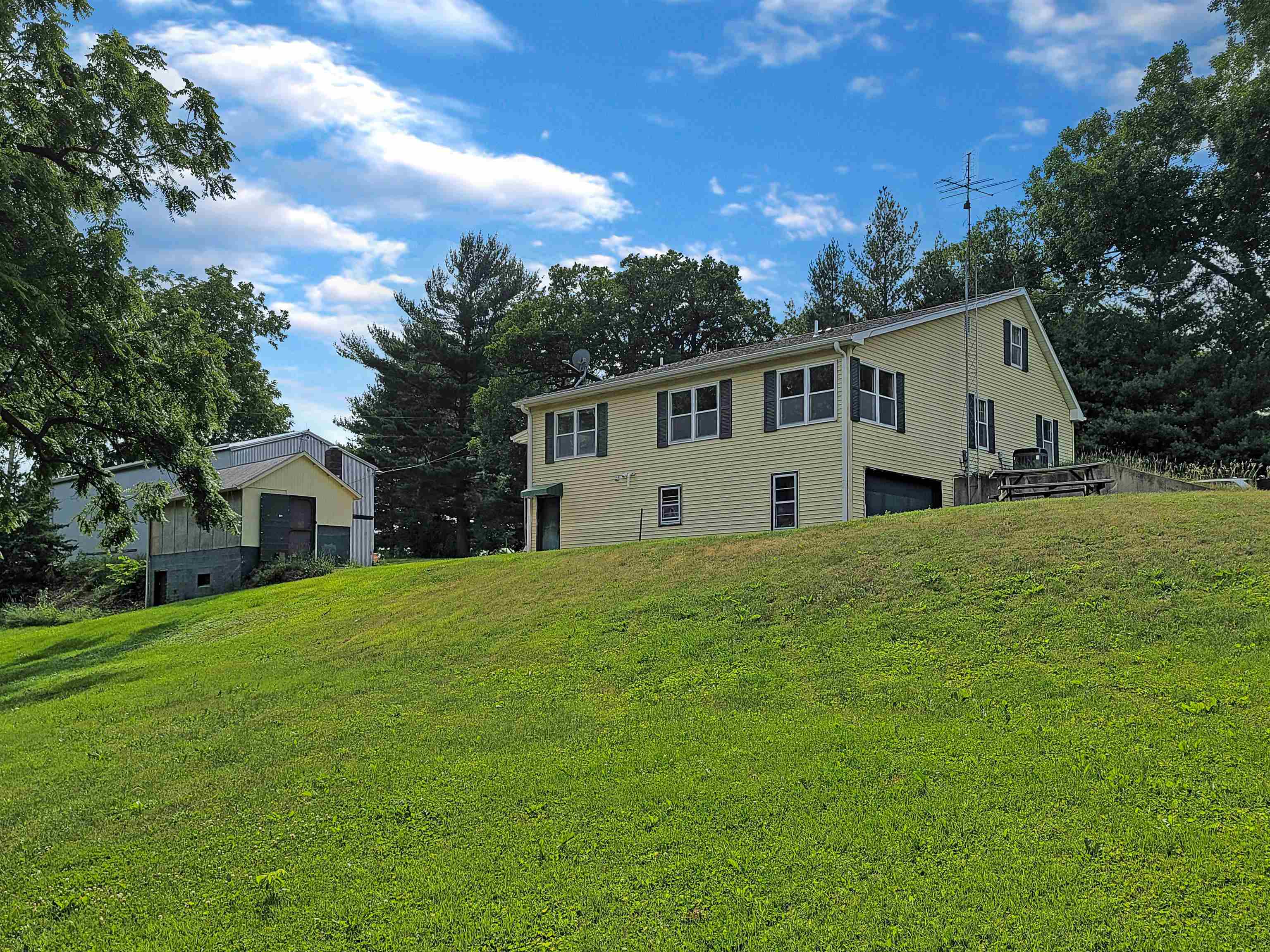 a front view of house with yard and green space