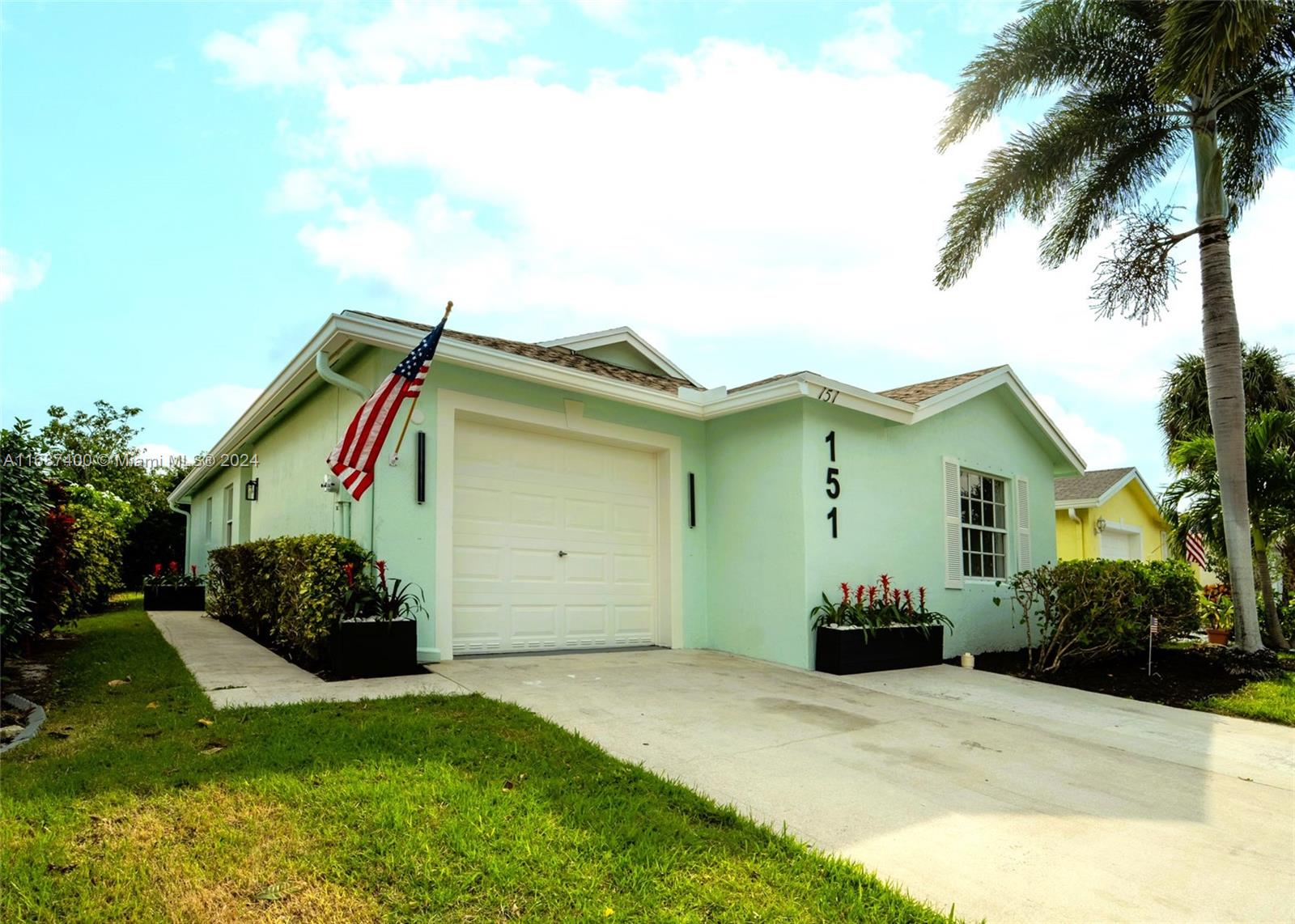 a front view of a house with a garden