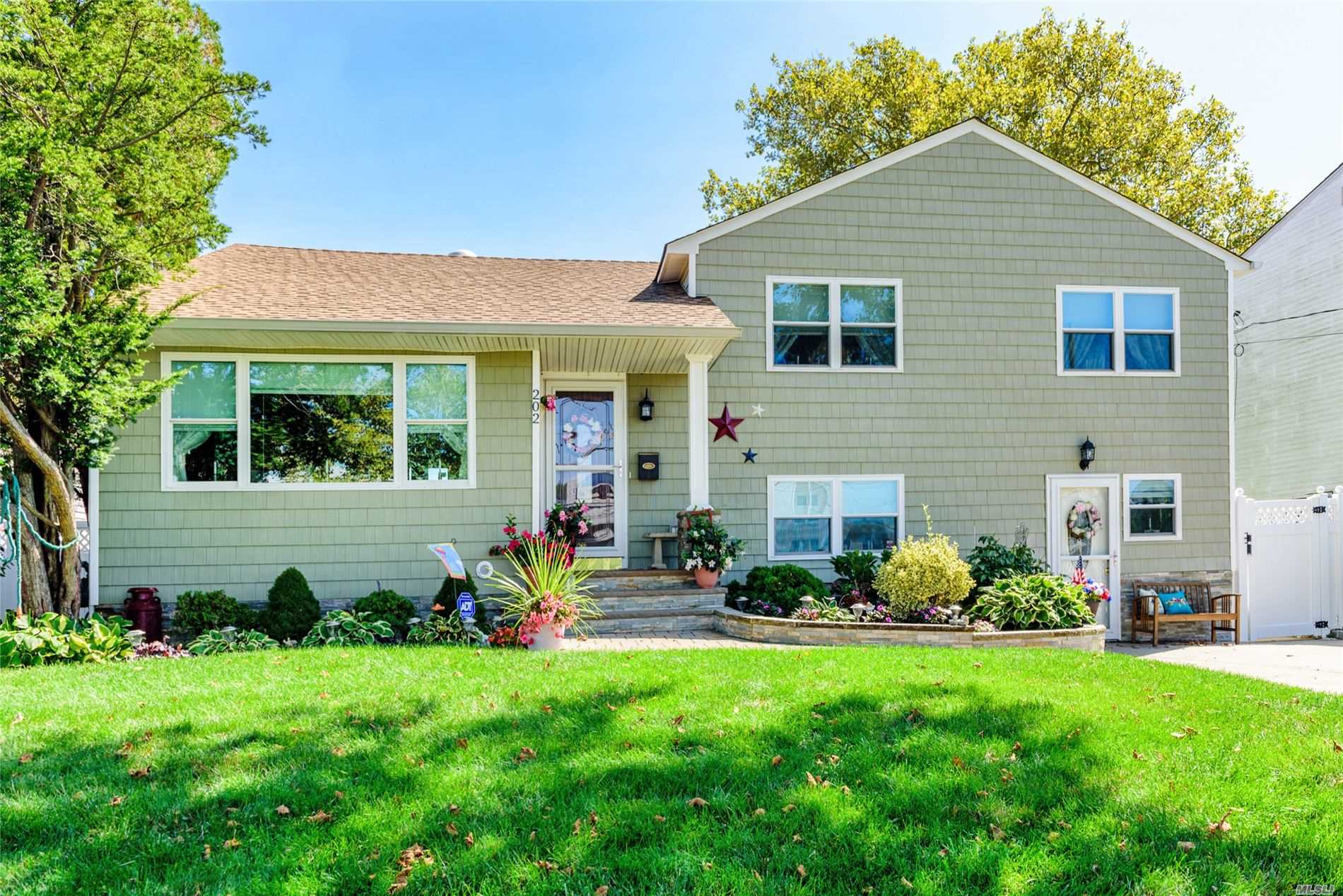 a view of a house with backyard sitting area and garden