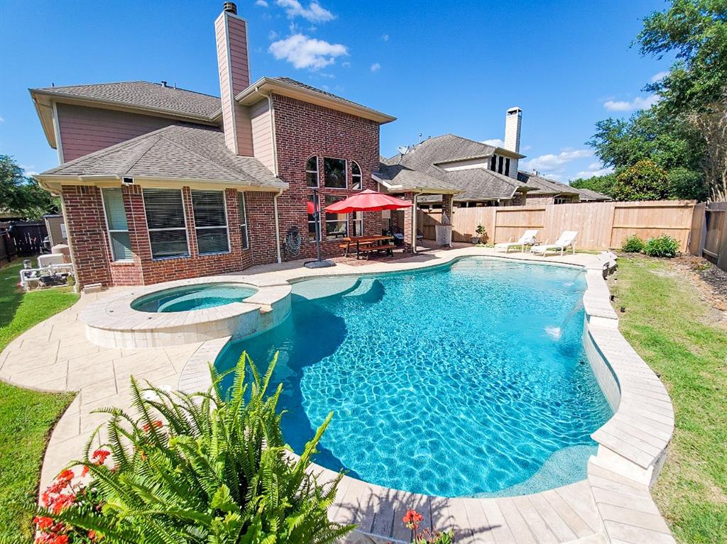 a swimming pool with outdoor seating yard and barbeque oven