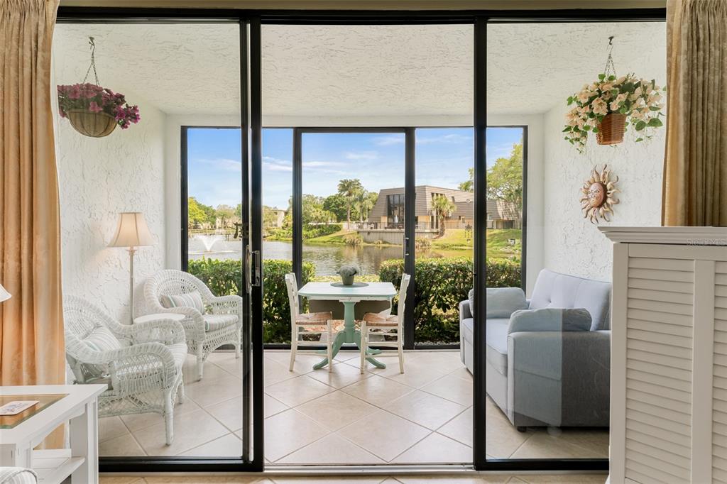 a living room with furniture and a floor to ceiling window