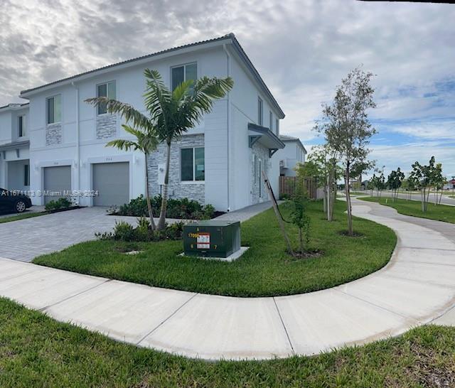 a front view of a house with a garden and plants