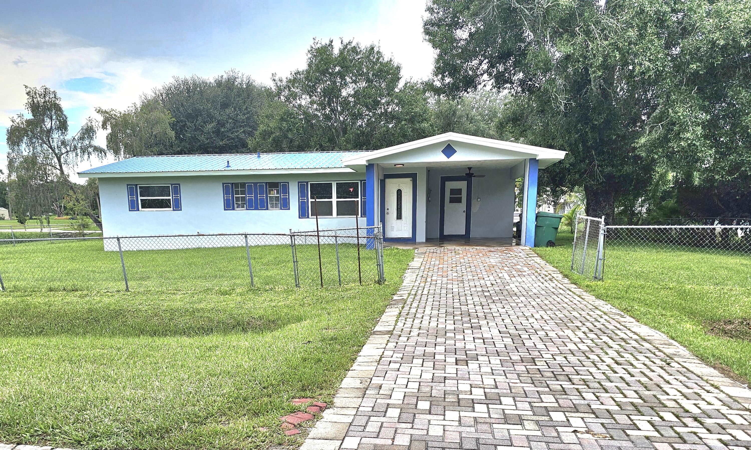 a front view of house with yard garden and trees