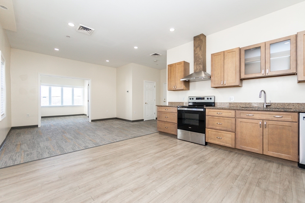 a kitchen with granite countertop white cabinets and white appliances