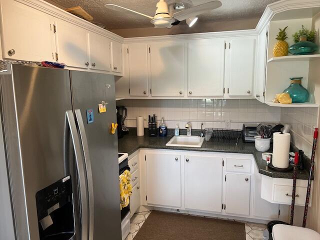 a kitchen with stainless steel appliances a refrigerator sink and cabinets