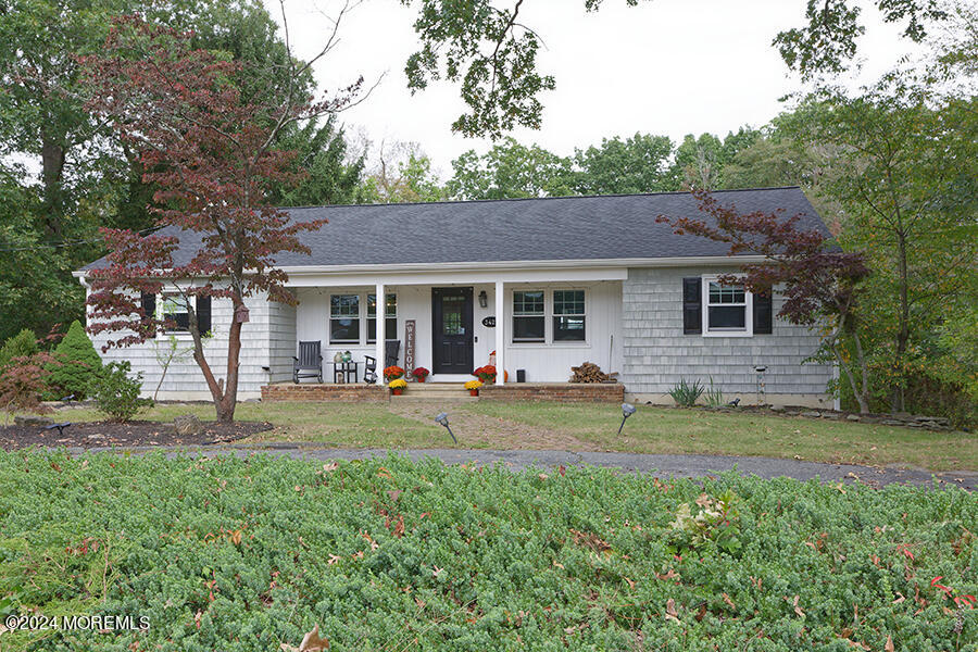 a view of a house with a yard and sitting area