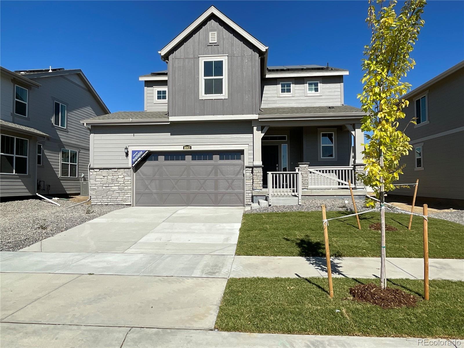 a view of a house with a patio and a yard