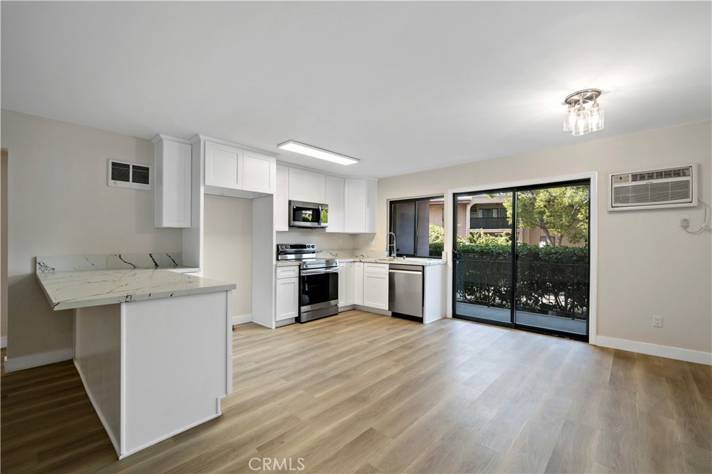 a kitchen with stainless steel appliances a stove top oven and a refrigerator