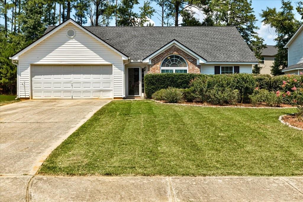 a front view of a house with a yard