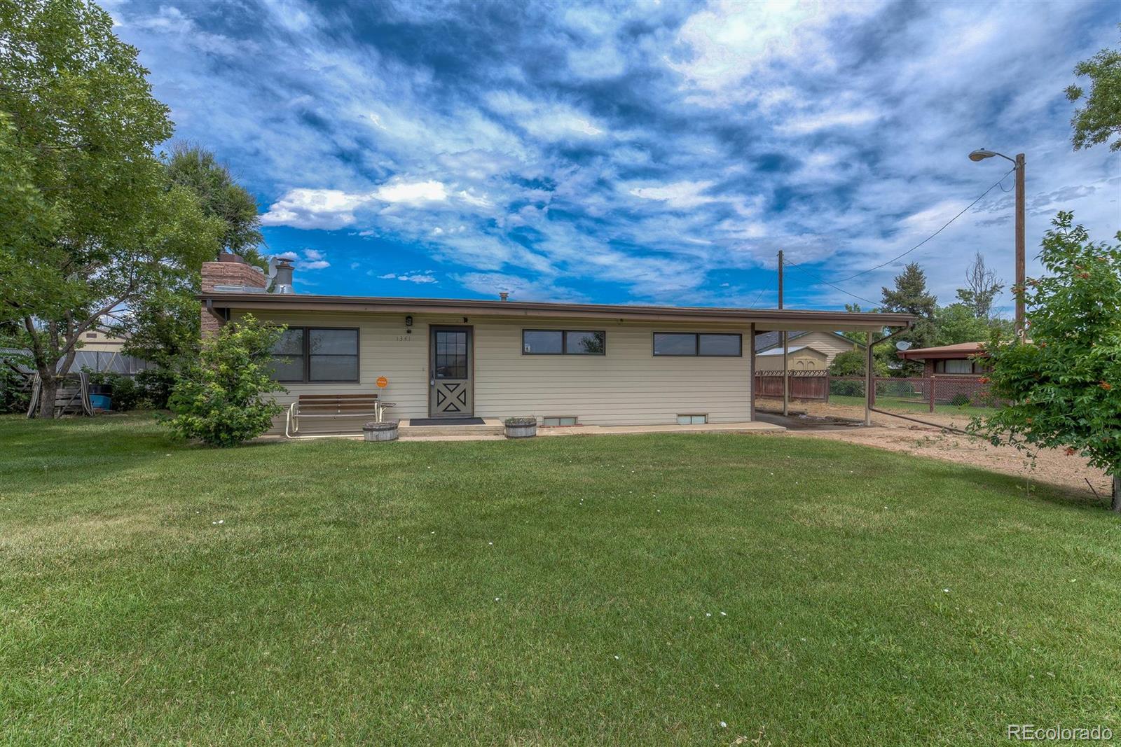 a view of a house with a backyard