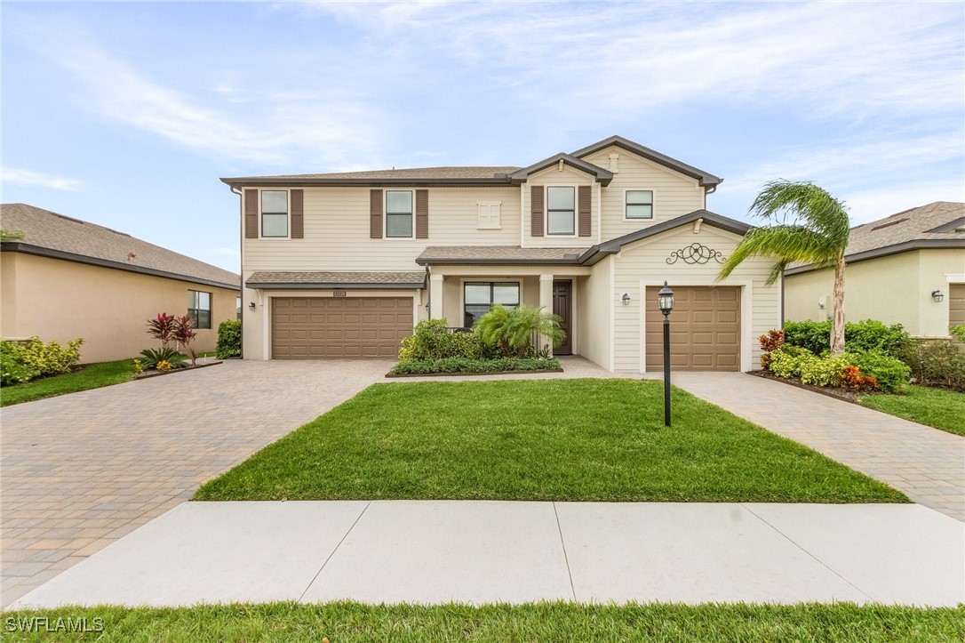 a front view of a house with a yard and garage