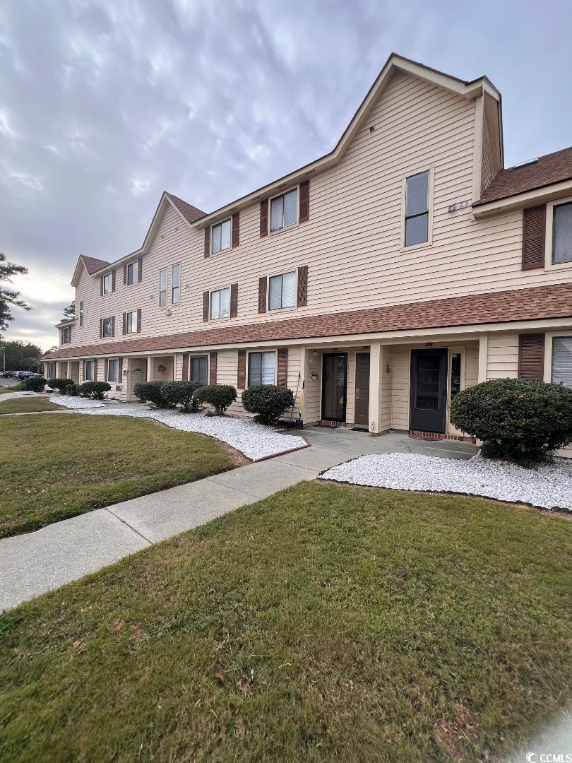 View of property with a front yard