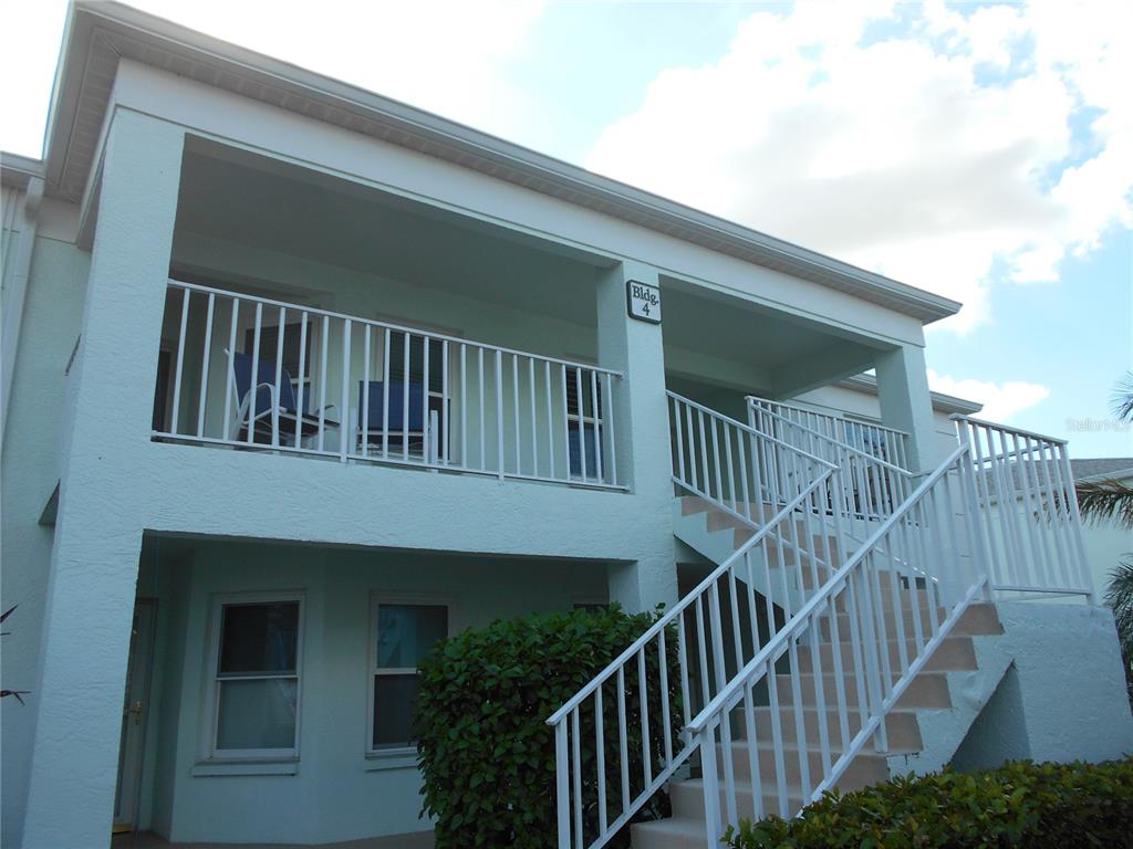 a view of balcony with deck and stairs