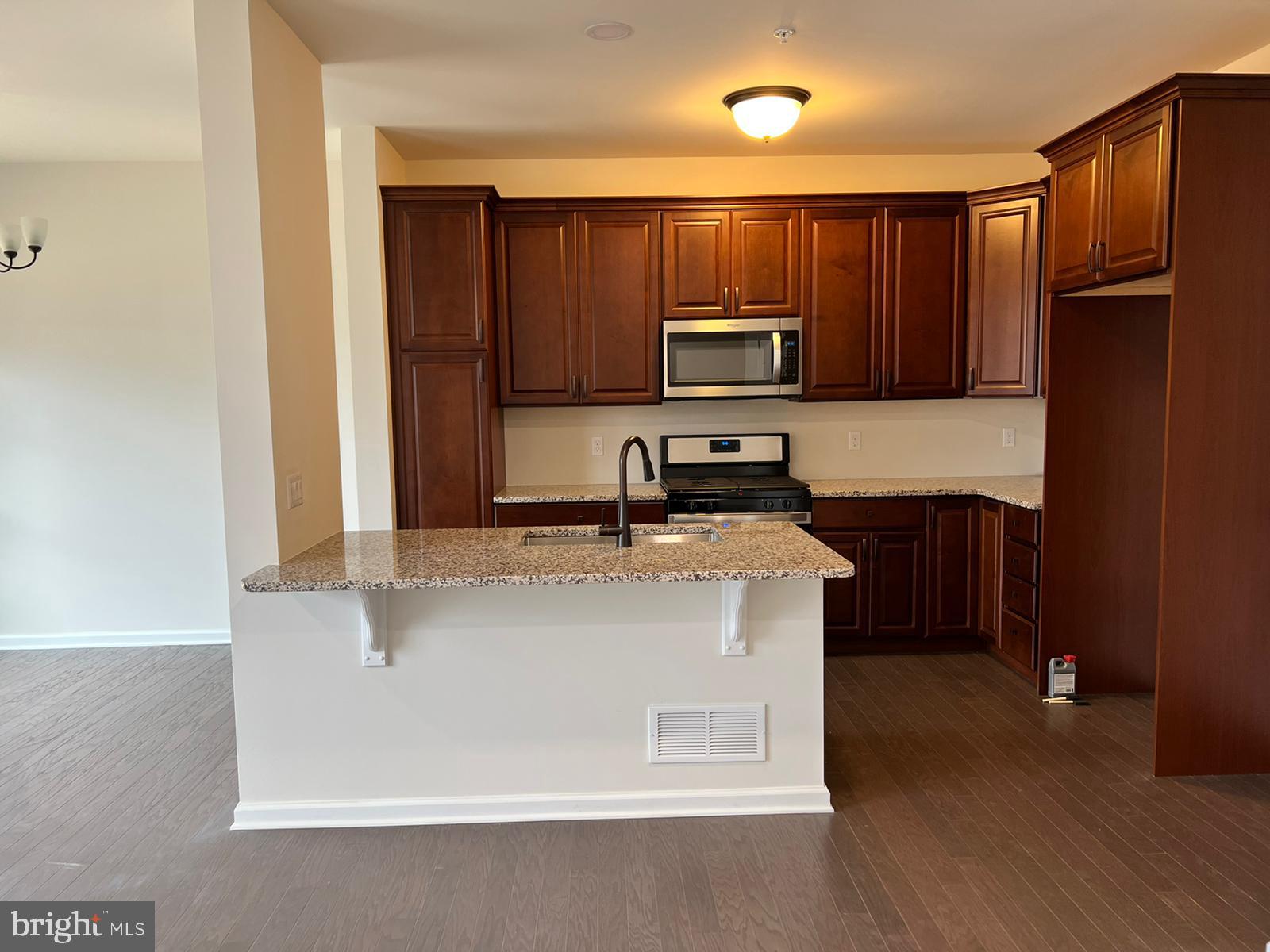 a kitchen with stainless steel appliances a refrigerator stove microwave and sink