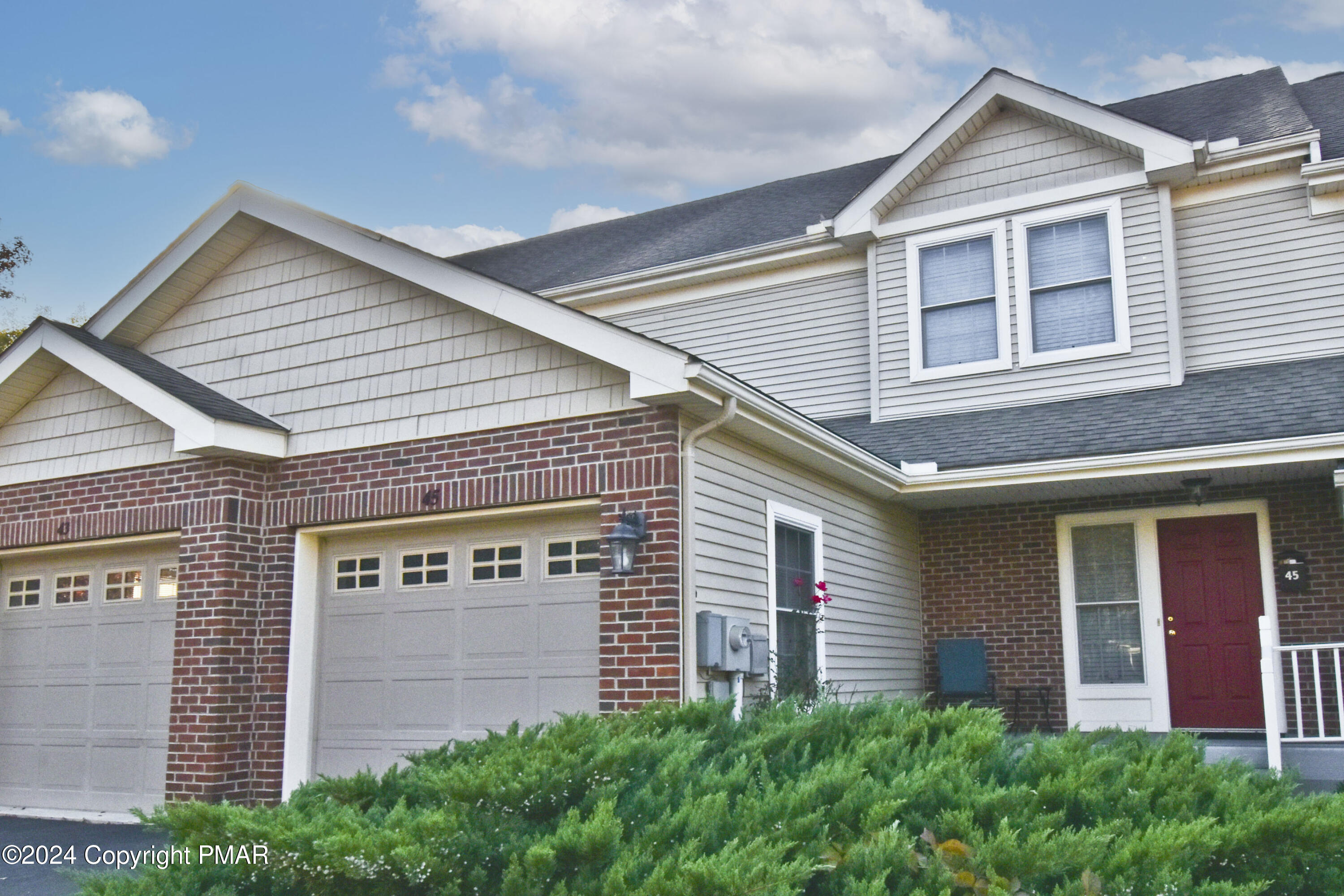 a front view of a house with garage