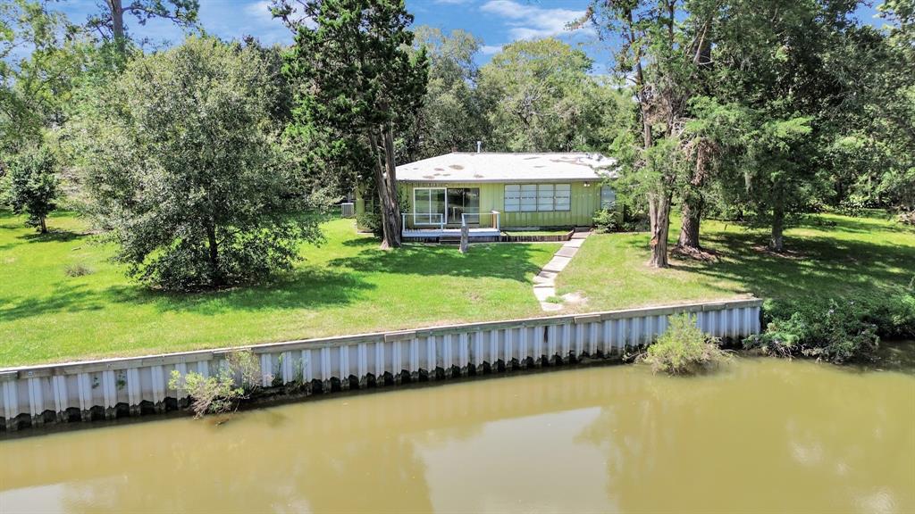 a view of a house with a swimming pool and sitting area