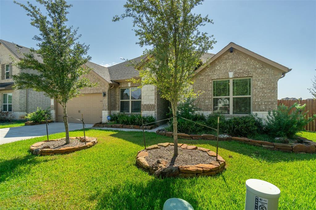 a view of a house with a swimming pool and a yard