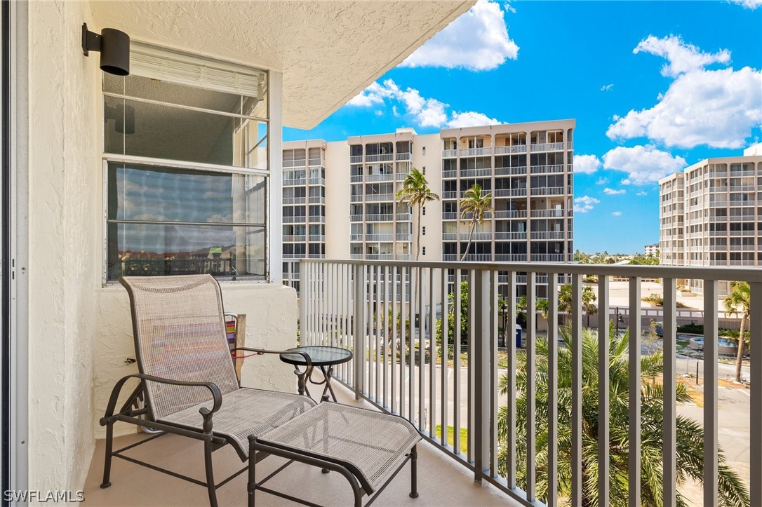 a view of a balcony with a couple of chairs