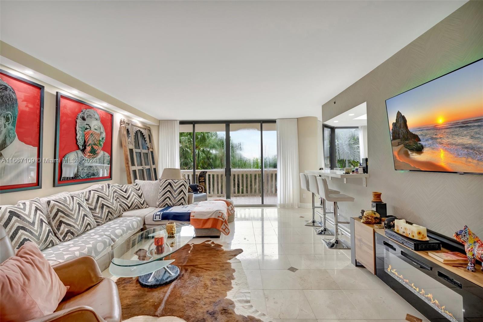 a living room with furniture and a floor to ceiling window