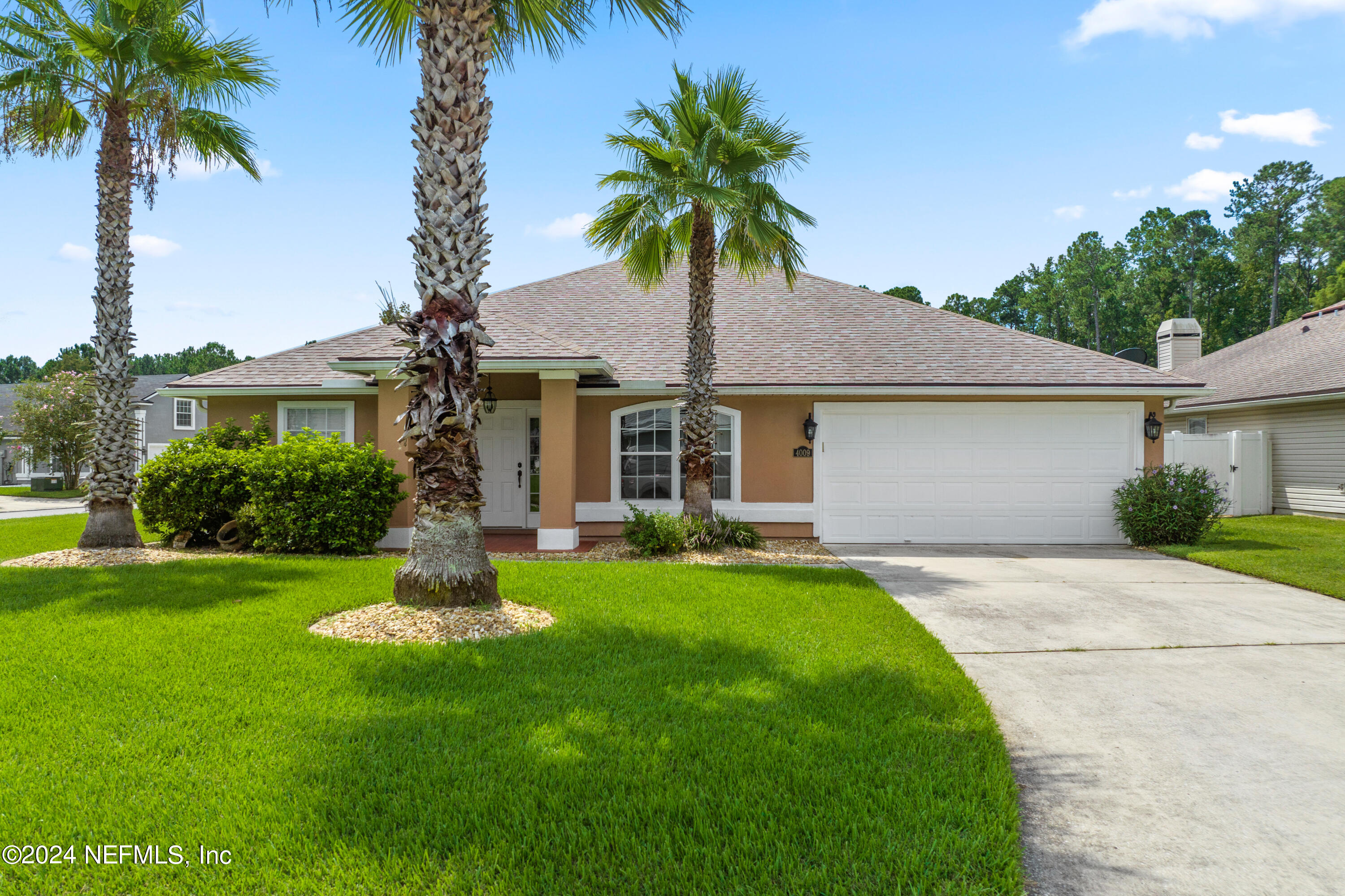 a front view of house with yard and green space