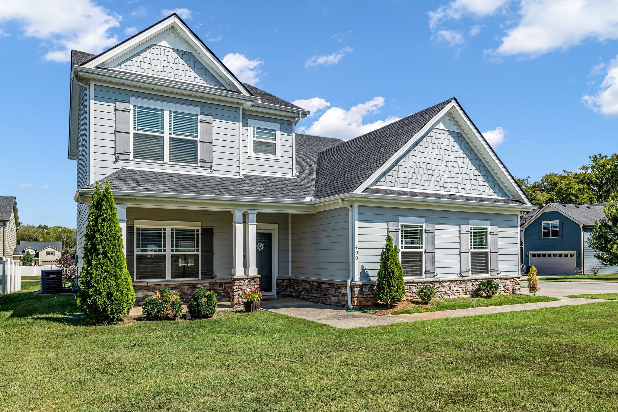 a front view of a house with a yard and porch