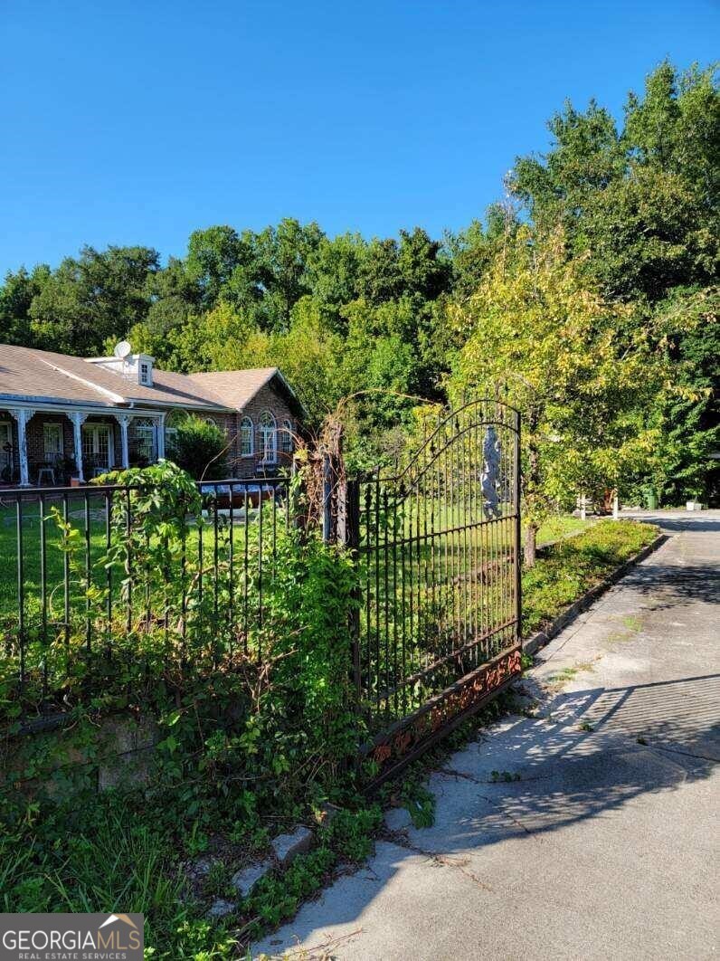 a view of a garden with wooden fence