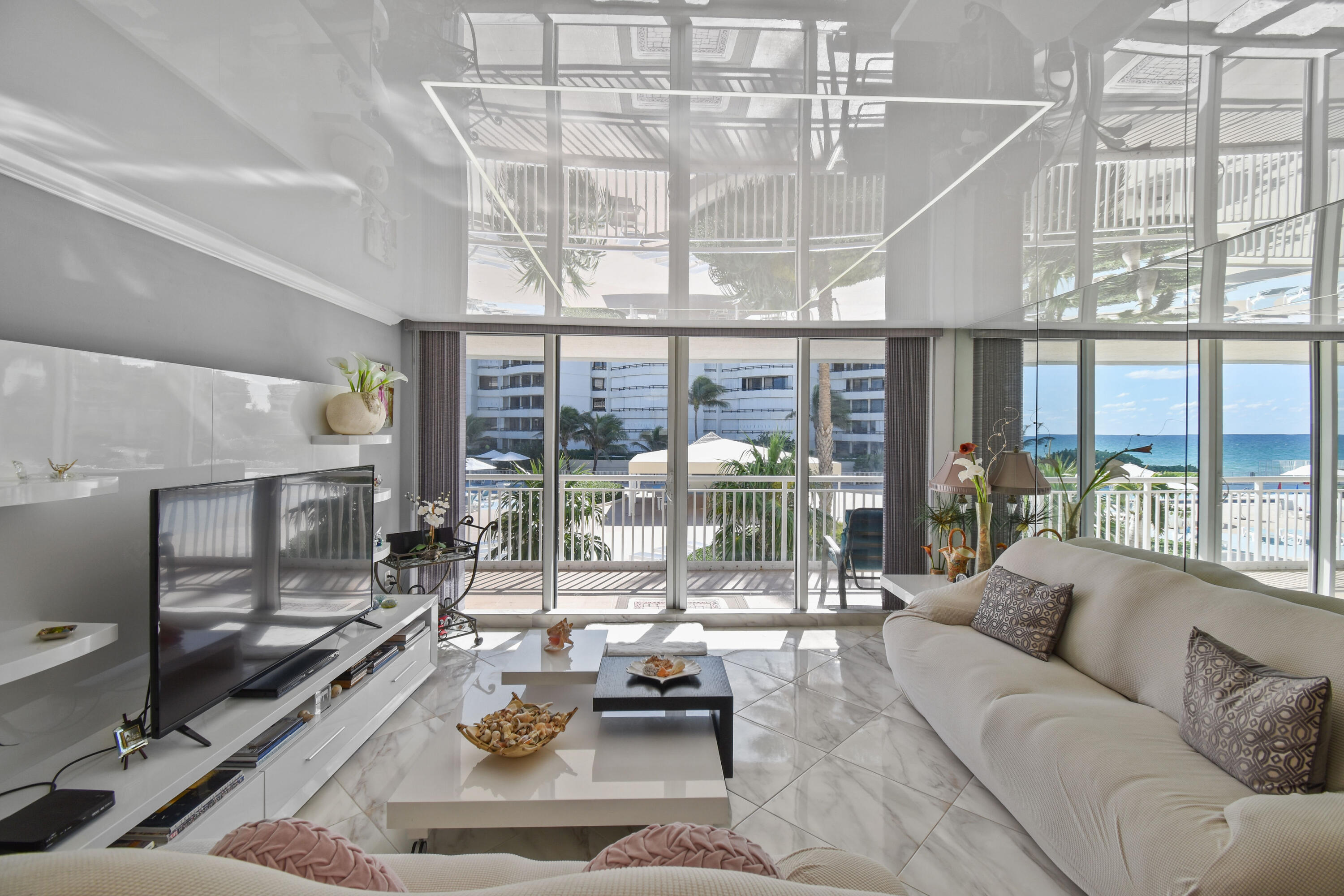 a living room with furniture and a floor to ceiling window