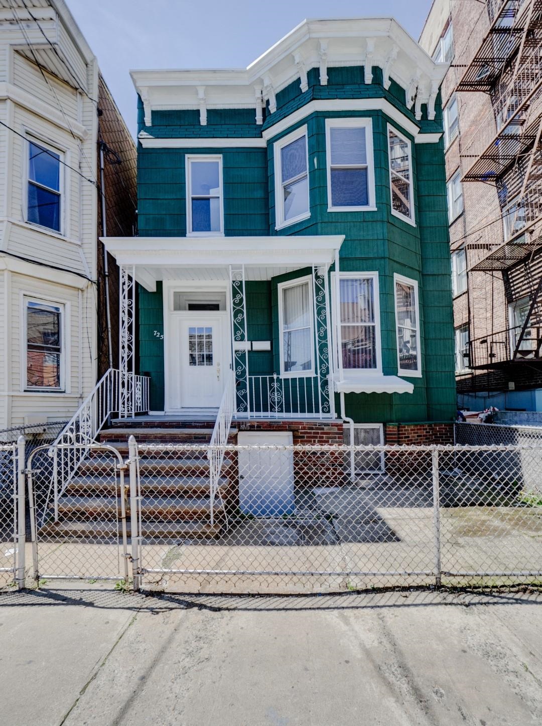 a front view of a house with a street