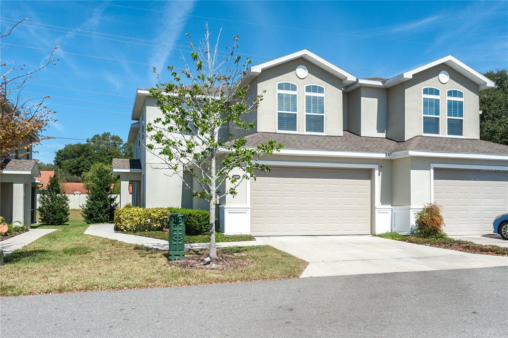 a front view of a house with a yard and garage