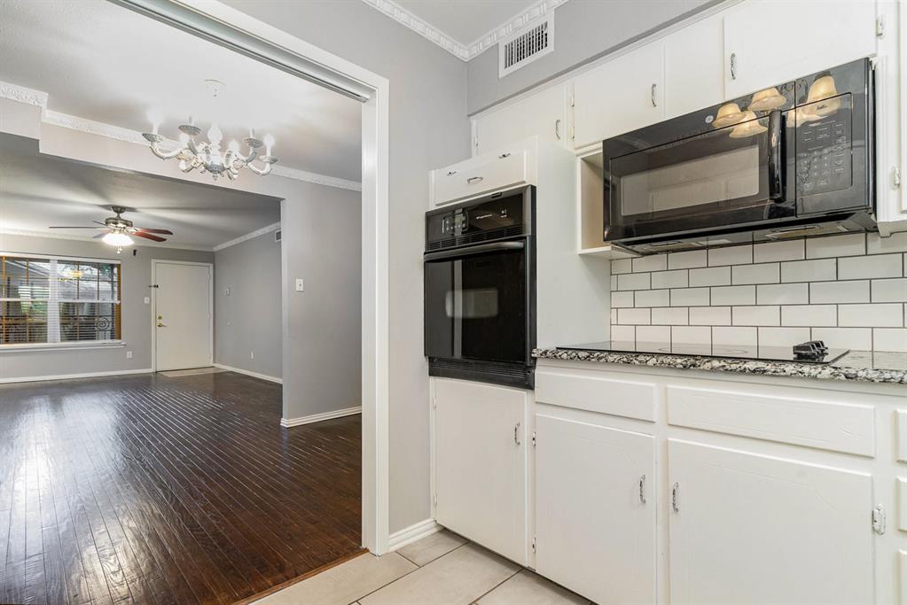 a kitchen with stainless steel appliances a stove microwave and cabinets