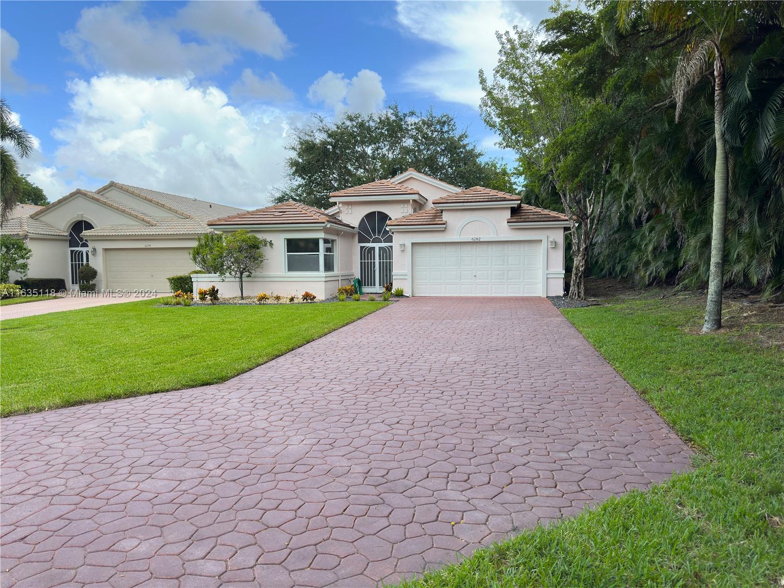 a front view of a house with a yard and garage