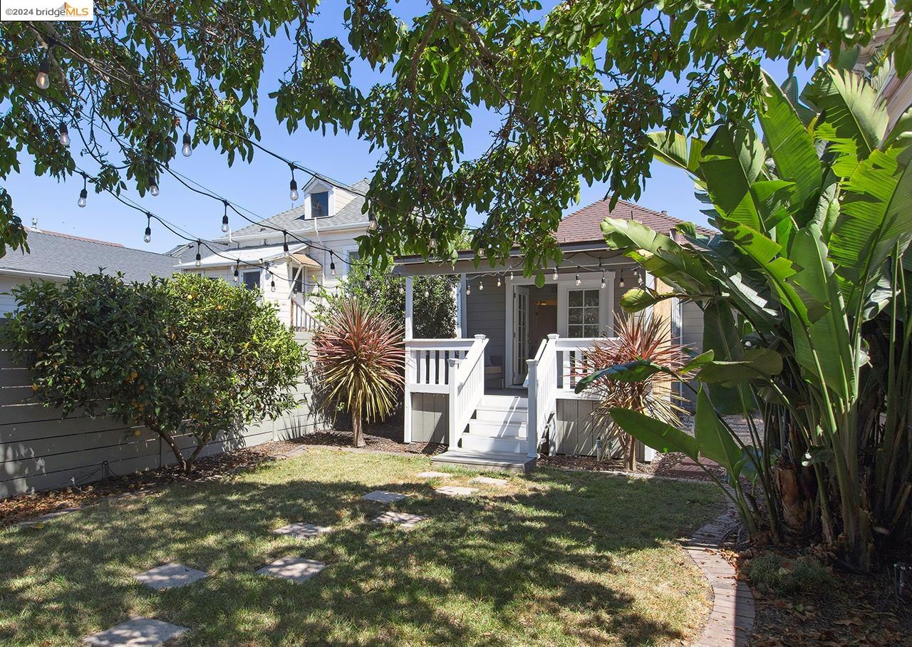 a view of a house with a tree and yard